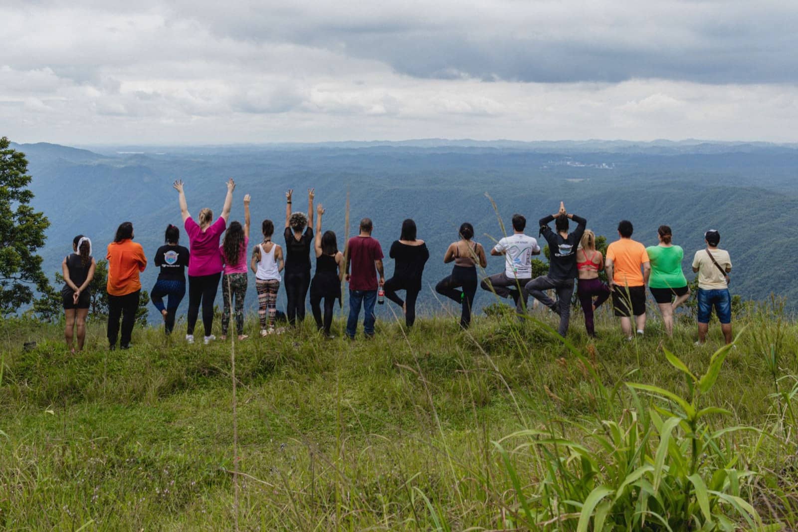 A group of travellers on a hilltop looking at the view