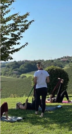 Mat Pilates on a lawn above the vineyards