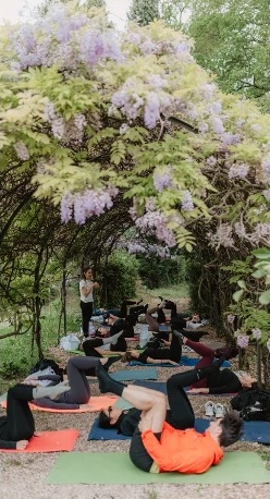 Mat Pilates under a wisteria pergola