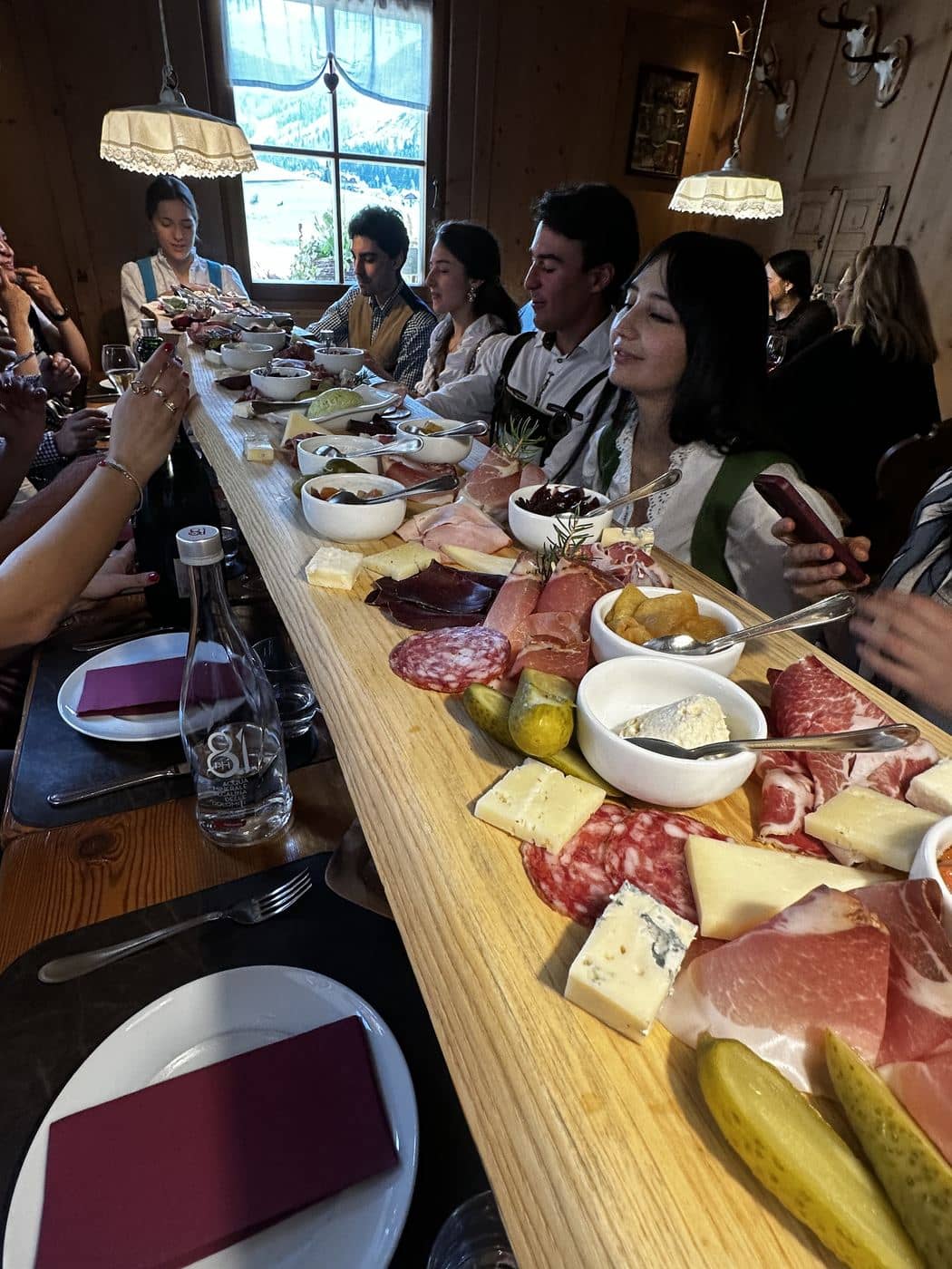 A team dinner at a long table in a baita